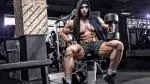 Guy-in-Hoodie-Posing-Barbell-Bench-Dumbbells.webp