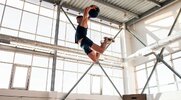 Fit and athletic man jumping with a medicine ball with explosive energy