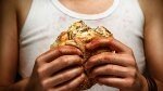 Person holding ultra processed food from a fast food restaurant