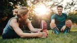 Healthy and Happy Couple Stretching on a Grassy field to improve their flexibility