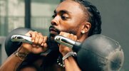 Rapper Olu working out with kettlebells