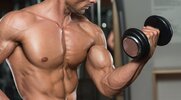 Muscular bodybuilder doing biceps workout with a bicep curl exercise