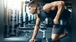 Fit man performing a single-arm dumbbell rows