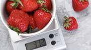 Weighing the serving size of strawberries according to the nutrition label