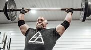 Strongman and powerlifting legend Nick Best performing a strict press exercise