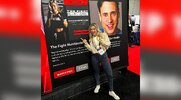 “The Fight Nutritionist” Jackie Kaminski in front of the muscle and fitness plus booth