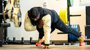 NFL football player Cesar Ruiz demonstrating a single arm pushup for his full body workout