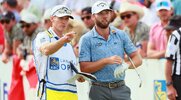 Professional Golfer Sam Burns strategizing with his caddy on a golf shot