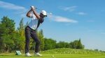 Golfer with a power and precise golf swing hitting an iron off the tee box