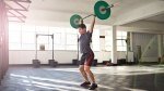 Fit Man in the gym performing a barbell clean and Push Press exercise