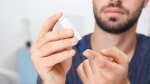 Diabetic man testing his blood sugar level with a diabetes test