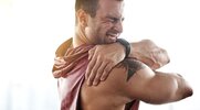 Fit man suffering pain from a sore shoulder