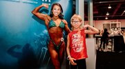 bodybuilding fan taking a picture with female bodybuilder at the Olympia Expo 2024