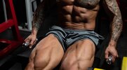 Fit muscular man performing leg lifts to develop muscular hamstrings