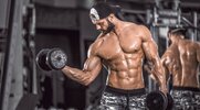 Bodybuilder Wearing A Black Hat Doing Dumbbell Biceps Curls Exercise for his supersets workout and hypertrophy training