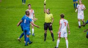 Soccer Referee giving a yellow card to a player on the field