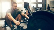 Fit Man exercising with a rowing workout for better conditioning