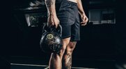 Fit man holding a kettlebell for the 4 week kettlebell transformation workout