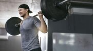 Fit man at the gym performing and strength and endurance workout to build his muscles