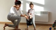 A mom and daughter lifting a kettlebell together for a workout plan for moms