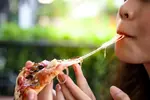 woman-eating-pizza-1024x683.webp