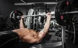 muscular-man-doing-bench-press.webp