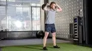 tell-performing-a-Sandbag-Sprawl-to-Squat-exercise.webp