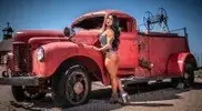 sing-in-daisy-dukes-nest-to-a-rusty-old-fire-truck.webp