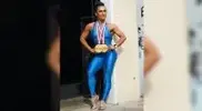 an-wearing-spandex-singlet-with-her-Olympia-medals.webp