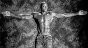 A-young-Carl-Lewis-with-his-arms-stretched-out.webp