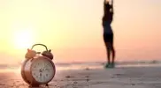 rning-Alarm-Clock-On-Beach-Girl-Stretching-Sunrise.webp