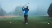 r-wearing-a-track-suit-playing-golf-on-a-foggy-day.webp