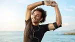 y-Fit-Man-Stretching-While-Listening-To-Ear-Phones.webp