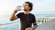 Black-Male-Runner-Drinking-Water-After-Running.webp