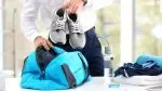 Business-Man-Packing-Gym-Bag-With-Sneakers.webp