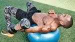 Man-doing-swiss-ball-dumbbell-bicep-fly-exercise.webp