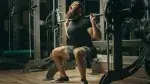 Bearded-Man-Struggling-With-Squat-At-Smith-Machine.webp