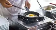 Cooking-Sunny-Side-Up-Eggs-In-A-Frying-Pan.webp