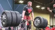 Andrew-Burton-deadlifting-6-tires-on-a-barbell.webp