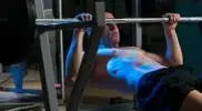 Man making inverted row mistakes as he works out his chest and arms