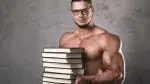 Muscular-Man-Wearing-Glasses-Holding-Stack-of-Books