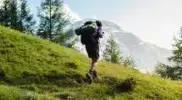 A lone hiker prepared and carrying a heavy load after training with hiking workouts