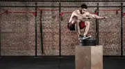 Fitness model working out his lower body and legs with a box jump exercise