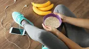 Girl-In-Fitness-Gear-Eating-Cereal-Banana