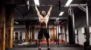 Fit Man performing a barbell snatch exercise as part of the 8 week snatch starters program