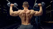 Fit man working out at the gym with a dumbbell back workout