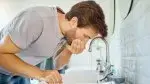 Man rinsing his mouth with a carbohydrate solution