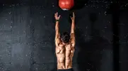 Muscular man working out with a medicine ball training program