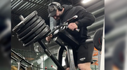 Bodybuilder Oleh Kryvyi performing Plate Loaded Standing Incline T-Bar Row for a back workout