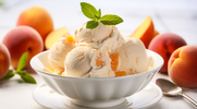 A bowl of Peach Ice Cream with a sprig of mint leaf on top